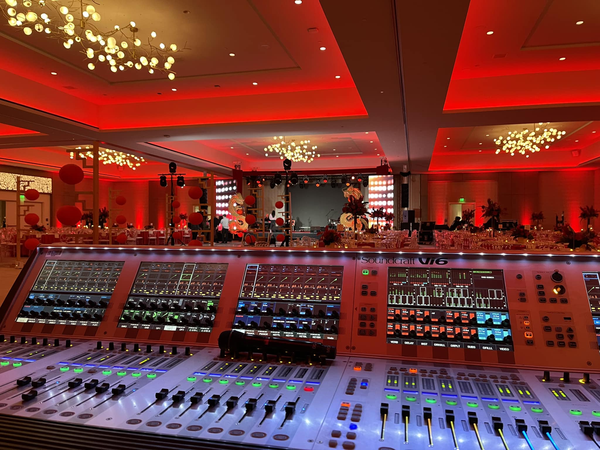 Backstage at major concert with broadcast and lighting consoles
