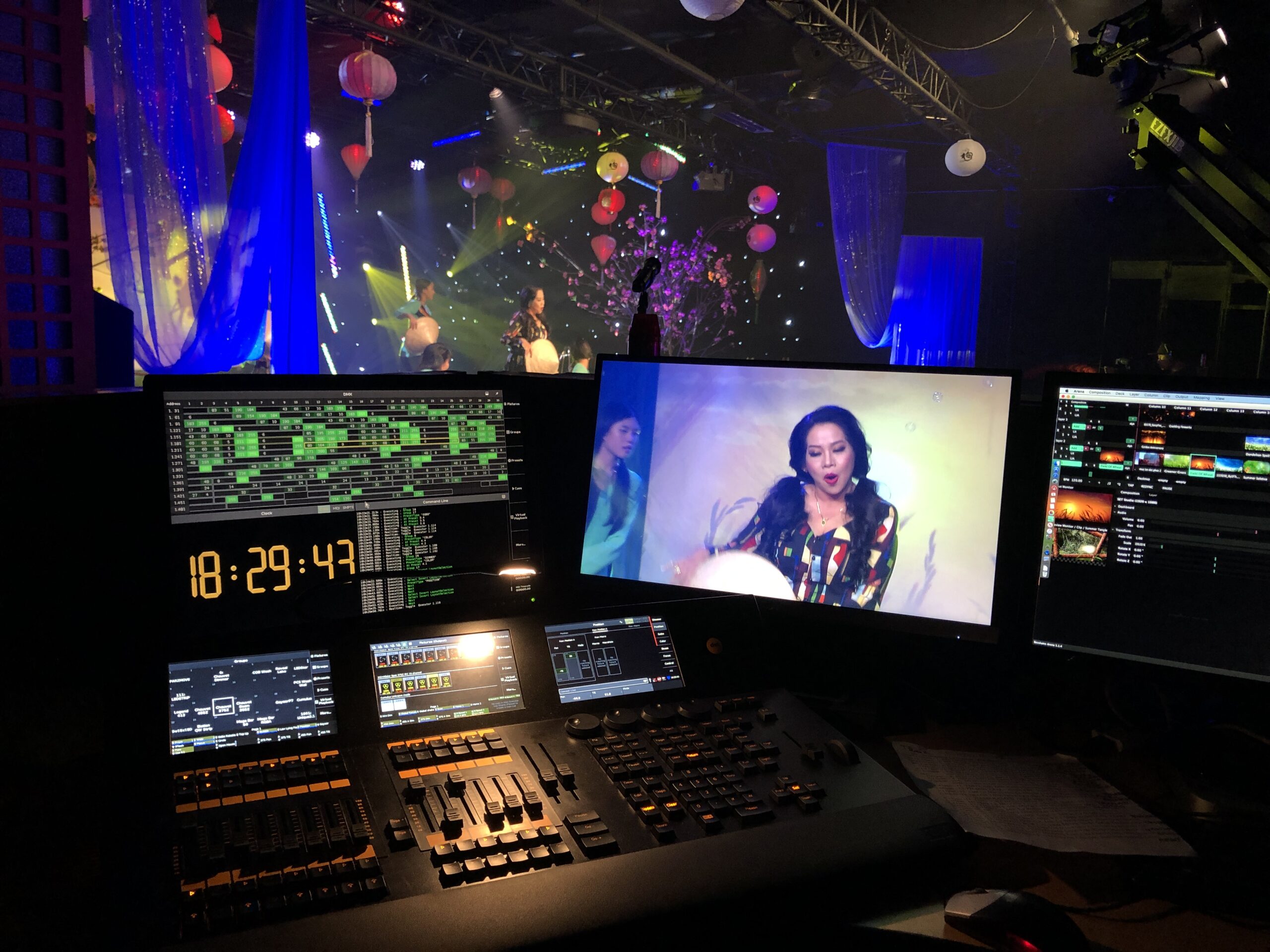 Lighting director at console with show-monitor screens