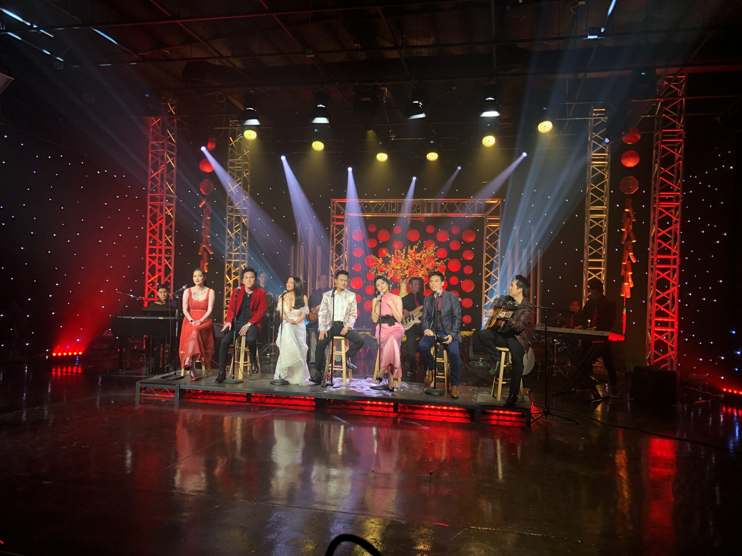 Concert stage with red lighting and moving heads