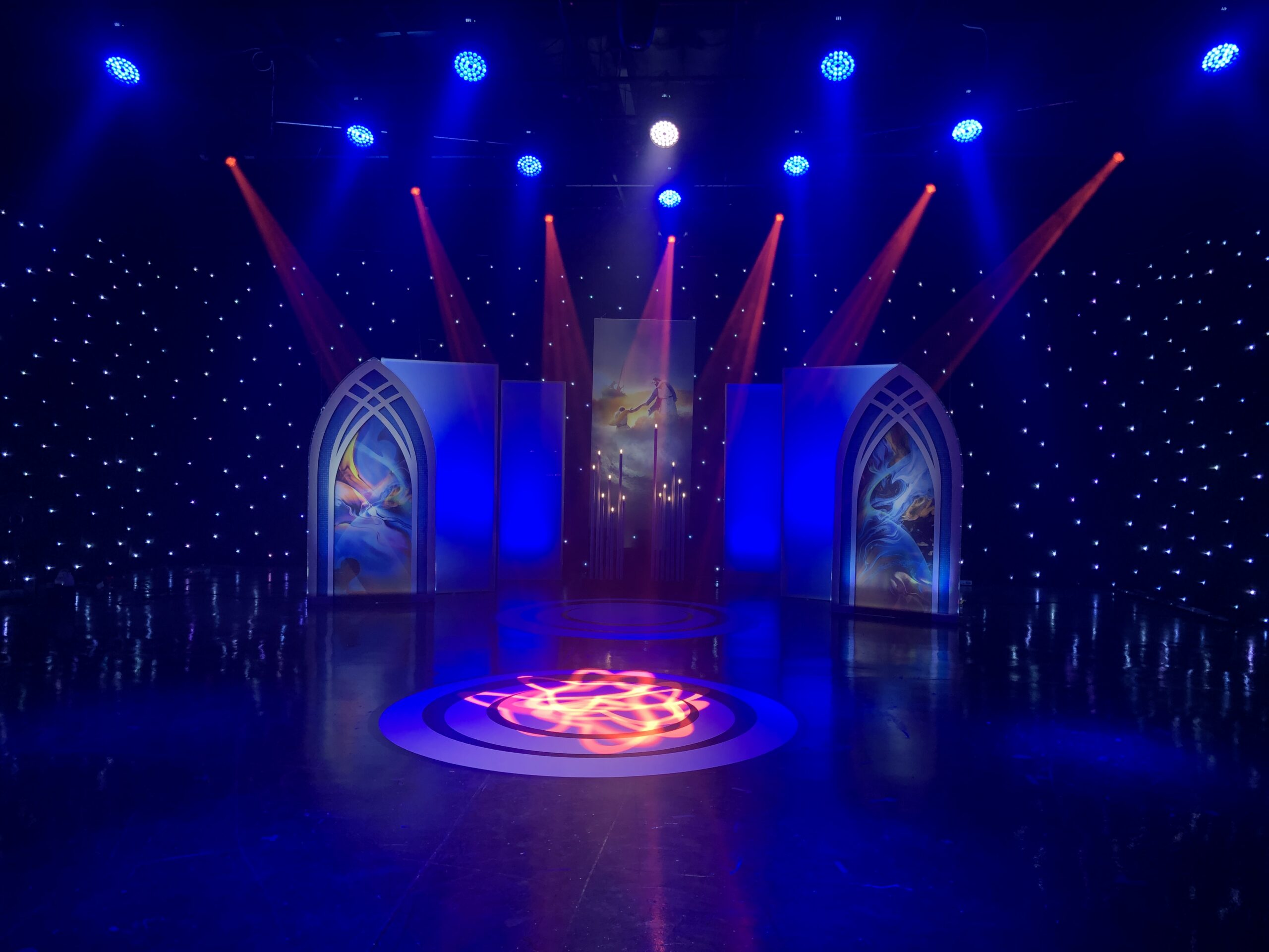 Stage with blue and green spot lighting fixtures